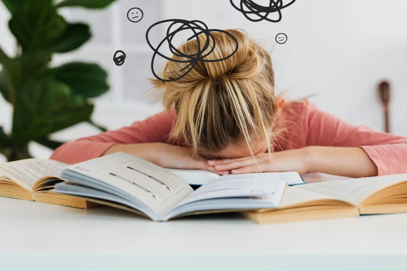 burn‑out Personne fatiguée la tête sur table, reflet des signes de burn‑out.