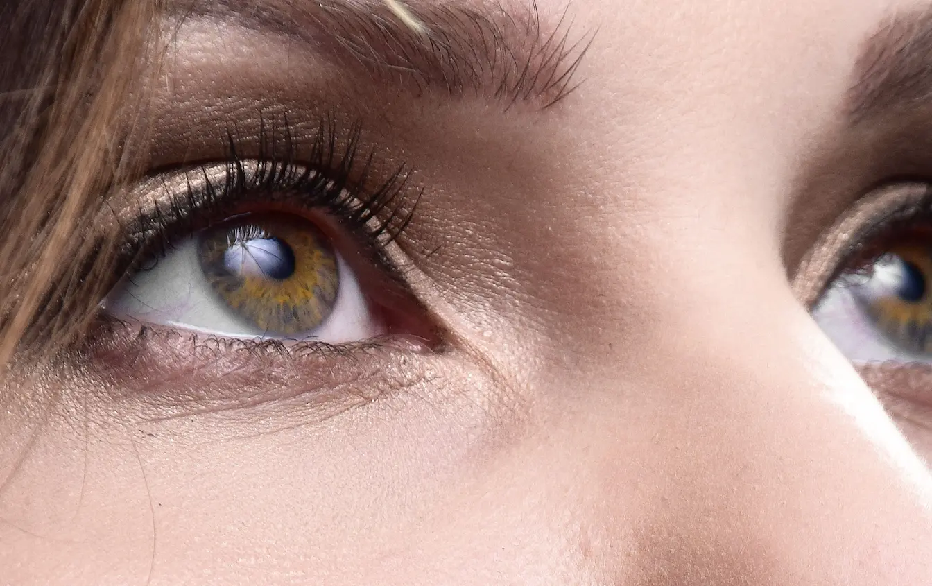 Paupière Gros plan sur yeux aux iris multicolores, symbole des tremblements de paupière et de leurs causes possibles.
